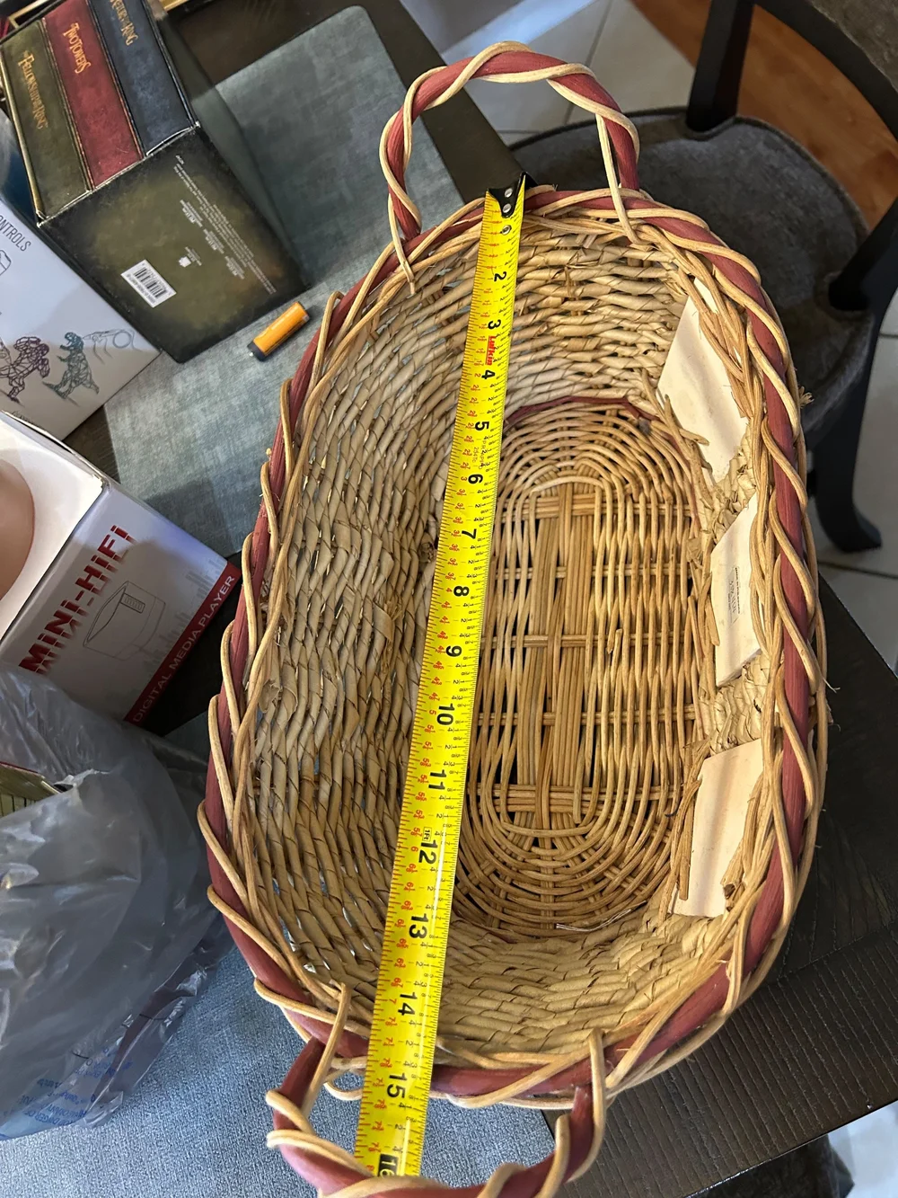 vintage woven wicker basket features hand-painted ceramic fruit tiles.